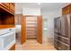 Pantry and stainless steel refrigerator in an updated kitchen with wood-look flooring at 5491 Hiram Rd, Powder Springs, GA 30127