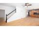 Open living room with hardwood floors, stairs, and view of kitchen at 5491 Hiram Rd, Powder Springs, GA 30127