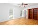 Bright room featuring neutral paint, hardwood floors, a ceiling fan, and built-in shelving at 5491 Hiram Rd, Powder Springs, GA 30127