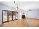 Open living room with hardwood floors, a fireplace, and sliding glass doors at 5491 Hiram Rd, Powder Springs, GA 30127