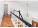 Bright staircase with wood treads, white risers, and black handrail leads upstairs at 5491 Hiram Rd, Powder Springs, GA 30127