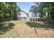 Spacious backyard with a deck and screened in patio, surrounded by a wooden fence at 990 Trestle Dr, Austell, GA 30106