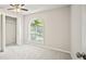 Clean bedroom features neutral walls, plush carpeting, arched window, and closet at 990 Trestle Dr, Austell, GA 30106