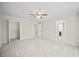 Spacious bedroom with plush carpeting, a ceiling fan, closet, and bright natural light at 990 Trestle Dr, Austell, GA 30106