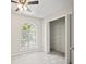 Bedroom featuring neutral walls, carpet, arched window, and organized closet space at 990 Trestle Dr, Austell, GA 30106
