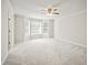 Bedroom featuring plush carpeting, a ceiling fan, and bright bay windows at 990 Trestle Dr, Austell, GA 30106