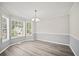 Dining room with three bay windows and modern floors at 990 Trestle Dr, Austell, GA 30106