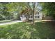 Traditional-style home with a manicured lawn and mature trees at 990 Trestle Dr, Austell, GA 30106