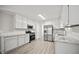 Well-lit kitchen with white cabinets, stainless steel appliances, and granite countertops at 990 Trestle Dr, Austell, GA 30106