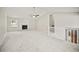 Bright living room featuring a fireplace, stairs to the second floor, and soft carpet at 990 Trestle Dr, Austell, GA 30106