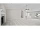 Open living room with fireplace, ceiling fan, and stairs leading to second level at 990 Trestle Dr, Austell, GA 30106