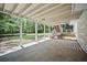 Covered outdoor patio space overlooking the backyard with lush greenery at 990 Trestle Dr, Austell, GA 30106