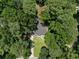 Aerial view of a home surrounded by lush trees and a green lawn at 3267 Sunderland Dr, Snellville, GA 30039