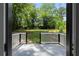 Backyard view from the deck with lush green trees and a play structure at 3267 Sunderland Dr, Snellville, GA 30039