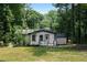 Quaint home with a small deck and lush greenery in the backyard at 3267 Sunderland Dr, Snellville, GA 30039
