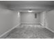 Spacious basement with gray carpet and neutral paint provides a blank canvas at 3267 Sunderland Dr, Snellville, GA 30039