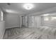 Bright basement with gray carpet and neutral paint, featuring natural light and multiple doors at 3267 Sunderland Dr, Snellville, GA 30039