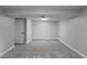 Finished basement space with gray carpeting and neutral painted walls at 3267 Sunderland Dr, Snellville, GA 30039