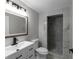 Bathroom featuring a vanity with a white cabinet, a gray tiled shower, and a toilet at 3267 Sunderland Dr, Snellville, GA 30039