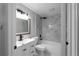 Modern bathroom with white vanity, gray-tiled shower, and a black faucet at 3267 Sunderland Dr, Snellville, GA 30039