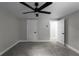 This bedroom features neutral walls, gray carpet, a ceiling fan, and white doors at 3267 Sunderland Dr, Snellville, GA 30039