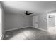 This bedroom features neutral walls, gray carpet, a ceiling fan, and white doors at 3267 Sunderland Dr, Snellville, GA 30039