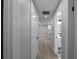 Hallway view leading to a bright kitchen with white cabinets and countertops at 3267 Sunderland Dr, Snellville, GA 30039