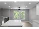 Eat-in kitchen featuring modern lighting, an island with quartz countertop, and a view of backyard trees at 3267 Sunderland Dr, Snellville, GA 30039
