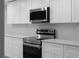 Modern kitchen with white cabinets, stainless steel appliances, and quartz countertops at 3267 Sunderland Dr, Snellville, GA 30039