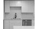 Bright kitchen featuring white cabinets, a stainless steel dishwasher, and a sleek black faucet at 3267 Sunderland Dr, Snellville, GA 30039