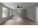 Living room with hardwood floors, ceiling fan, and bright natural light from windows at 3267 Sunderland Dr, Snellville, GA 30039