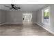 Open-concept living room with hardwood floors, ceiling fan, and view into kitchen at 3267 Sunderland Dr, Snellville, GA 30039