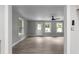 Open-concept living room with windows, hardwood floors, and neutral paint at 3267 Sunderland Dr, Snellville, GA 30039