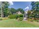 Beautiful backyard with lush lawn, landscaping, and charming playhouse creates a private outdoor oasis at 3370 Battlement Cir, Loganville, GA 30052