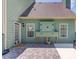 The exterior showcases a covered patio featuring outdoor furniture and a built-in kitchen area at 3370 Battlement Cir, Loganville, GA 30052