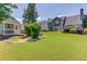 Private backyard featuring a playhouse, well-maintained lawn, and ample space for outdoor activities at 3370 Battlement Cir, Loganville, GA 30052