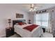 Comfortable bedroom featuring a queen-sized bed, ceiling fan, and neutral decor at 3370 Battlement Cir, Loganville, GA 30052