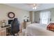 Bright bedroom features a ceiling fan, a large window, and a desk area for working from home at 3370 Battlement Cir, Loganville, GA 30052