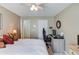 A bedroom with a work space, light walls, and a bed with decorative pillows at 3370 Battlement Cir, Loganville, GA 30052