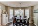 Cozy eat-in kitchen area with pendant lighting, bay windows, and a round table perfect for Gathering meals at 3370 Battlement Cir, Loganville, GA 30052