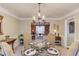 Stylish dining room with a contemporary chandelier and view into the living room at 3370 Battlement Cir, Loganville, GA 30052