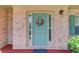 Close-up of a front door with decorative wreath, sidelights, and brick surround at 3370 Battlement Cir, Loganville, GA 30052