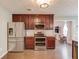 Modern kitchen boasts stainless steel appliances, sleek cabinetry, and hardwood floors, open to living area at 3370 Battlement Cir, Loganville, GA 30052