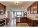 Gourmet kitchen features stainless appliances, granite counters, breakfast nook and dark wood cabinets and flooring at 3370 Battlement Cir, Loganville, GA 30052