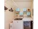 Well-organized laundry room features modern washer and dryer units with ample shelving for storage at 3370 Battlement Cir, Loganville, GA 30052
