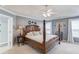 Comfortable main bedroom features a four-poster bed, ceiling fan, and neutral decor at 3370 Battlement Cir, Loganville, GA 30052