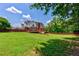 Expansive backyard featuring lush green grass, a wooden deck, and a secure fence, ideal for outdoor enjoyment at 4167 Alayna Lee Cir, Mcdonough, GA 30252