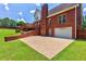 Spacious backyard with a brick patio and a detached garage, perfect for outdoor activities and storage at 4167 Alayna Lee Cir, Mcdonough, GA 30252