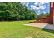 Lush backyard featuring mature trees and a well-maintained lawn, providing a private and serene outdoor space at 4167 Alayna Lee Cir, Mcdonough, GA 30252