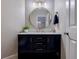 Bathroom vanity with dark cabinets, gold hardware, and a round mirror at 4167 Alayna Lee Cir, Mcdonough, GA 30252